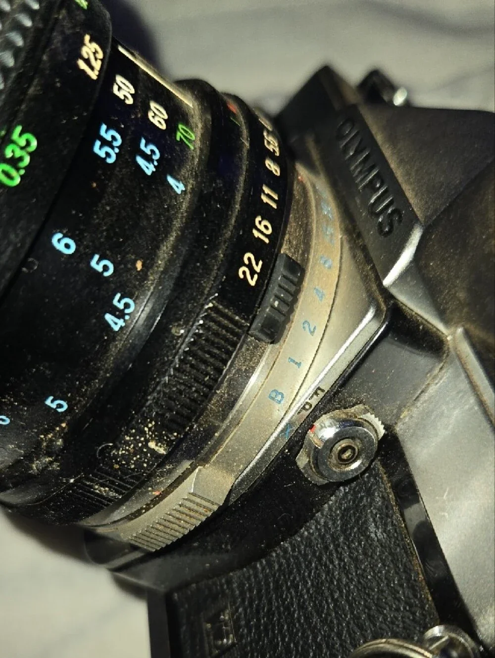 Olympus OM-1 Silver and Black Film SLR with Black Zoom Lens